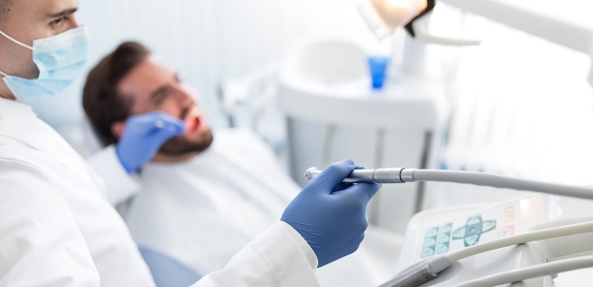 Patient receiving urgent care from an emergency dentist in Johnstone for immediate dental relief and treatment