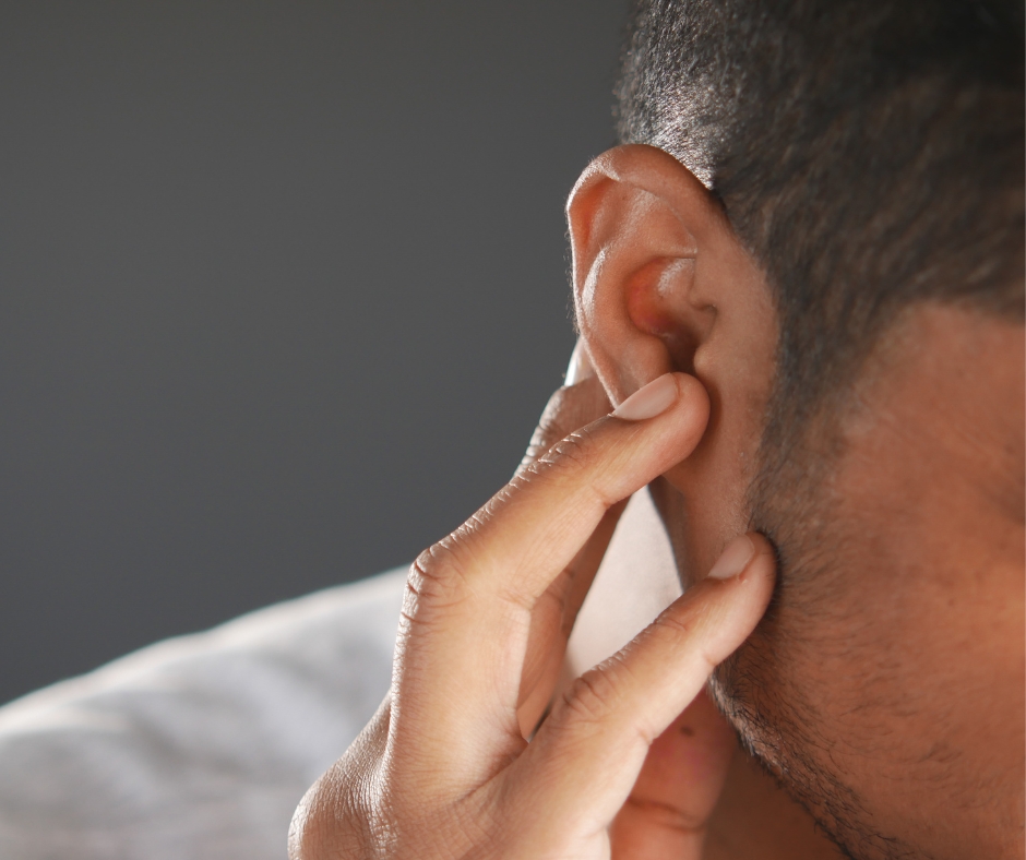 Doctor performing ear wax removal using micro suctioning method.